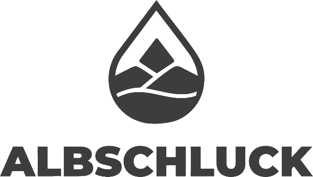 Logo von Albschluck, bestehend aus einer Tropfenform und stilisierter Landschaft der Schwäbischen Alb.